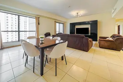 a living room with a table and chairs and a couch at Centrally Located Close to Beach in Dubai