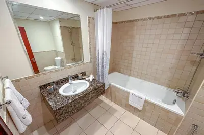 a bathroom with a sink and a bath tub at Centrally Located Close to Beach in Dubai
