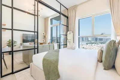 a bedroom with a white bed and a large window at Located Minutes walk to Dubai Hills Park, Near Dubai Hills Mall , Socio Tower 1, Dubai Hills by Deluxe Holiday Homes in Dubai