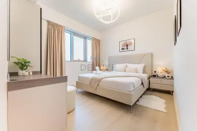 a white bedroom with a large bed and windows at Golf Course And Canal Views, Mins to Dubai Marina And Dubai Mall, Golf Towers T1 - The Greens by Deluxe Holiday Homes in Dubai