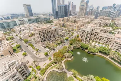 an aerial view of a city with a river and buildings at Golf Course And Canal Views, Mins to Dubai Marina And Dubai Mall, Golf Towers T1 - The Greens by Deluxe Holiday Homes in Dubai