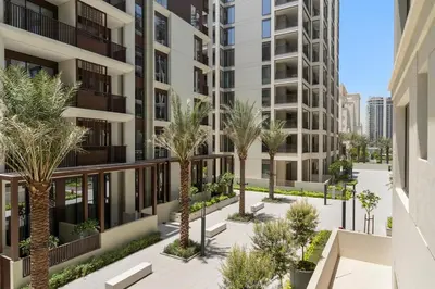 an image of an apartment complex with palm trees at Stylish 2BR at Creek Grove Near Downtown in Dubai