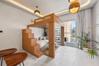 a bedroom with a bed and a balcony at Art Studio - Cozy Loft, Fireplace, City Vistas in Dubai
