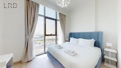 a bedroom with a large bed with a large window at Cozy and Modern 1BR for 2 in Dubai