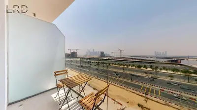 a balcony of a building with a view of a highway at Cozy and Modern 1BR for 2 in Dubai