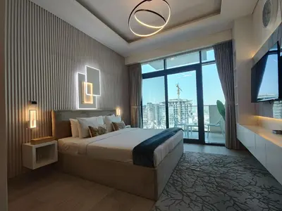 a bedroom with a large bed and a large window at Farhad Azizi Residence Al Jaddaf in Dubai