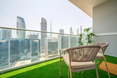 a balcony with a chair and a view of the city at Stylish 1BR - Burj Khalifa View in Dubai