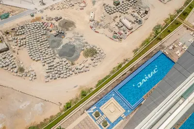 an overhead view of a construction site with a pool at Stylish 1BR - Burj Khalifa View in Dubai