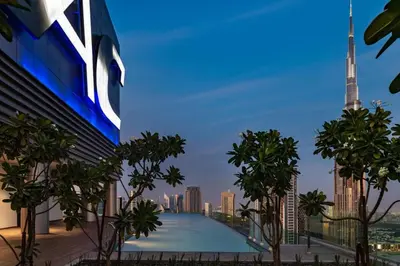 a view of the city skyline from a building with a swimming pool at Ultra-Luxury Midtown 2 Bed Full Burj Khalifa Views in Dubai