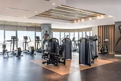 a gym with treadmills and exercise equipment in a building at Ultra-Luxury Midtown 2 Bed Full Burj Khalifa Views in Dubai