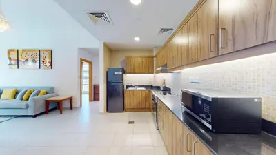 a kitchen with a microwave and a couch in a room at Vacationer I Premium 1 Bedroom I Canal View I Business Bay I Free Gym, Pool, Parking & Wi-Fi in Dubai