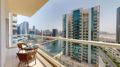 a balcony with two chairs and a view of a city at Vacationer I Premium 1 Bedroom I Canal View I Business Bay I Free Gym, Pool, Parking & Wi-Fi in Dubai