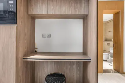 a room with a wooden wall with a white object in it at Stylish Studio in The Autograph in Dubai