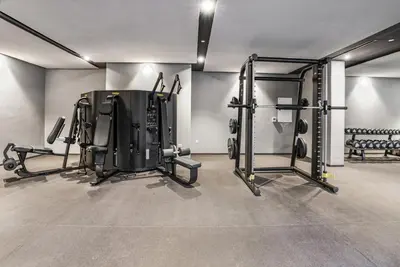 a gym with several equipment in a room at Stylish Studio in The Autograph in Dubai