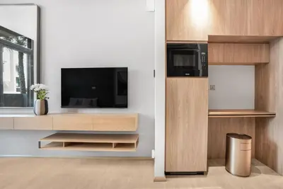 a living room with a tv in a wall at Stylish Studio in The Autograph in Dubai