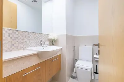 a bathroom with a sink and a toilet at Vogue Downtown Bellevue Towers near Burj Khalifa and Dubai Mall, One Bedroom Apartment with City View, Full Access to all Amenities in Dubai