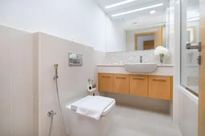 a bathroom with a sink and a toilet at Vogue Downtown Bellevue Towers near Burj Khalifa and Dubai Mall, One Bedroom Apartment with City View, Full Access to all Amenities in Dubai