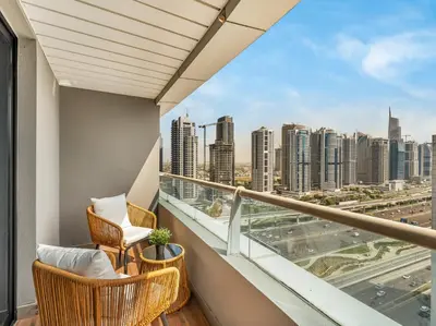 a balcony with chairs and a view of the city at Luxury 1 Bedroom Marina Views Walk to Metro and Beach in Dubai