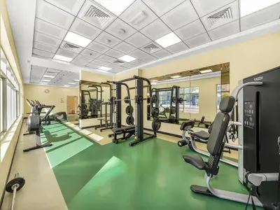 a gym with treadmills and ellipticals at Luxury 1 Bedroom Marina Views Walk to Metro and Beach in Dubai