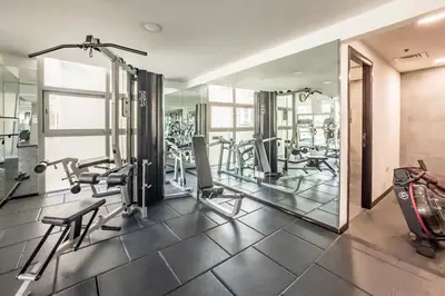 a gym with treadmills and ellipticals and mirrors at Luxury 2 BHK in Dubai Marina By dPie DEC 1907 in Dubai