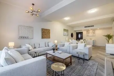 a living room with white couches and a table at Luxury 2 BHK in Dubai Marina By dPie DEC 1907 in Dubai