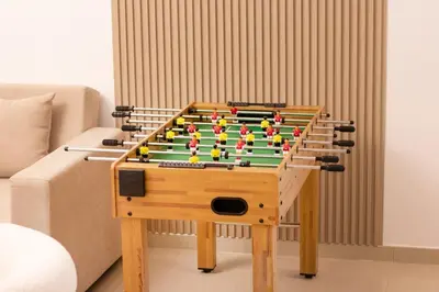 a wooden foosball table withfitsneauneauquartered at Luxury 3BHK in Dubai Marina DEC 1307 in Dubai