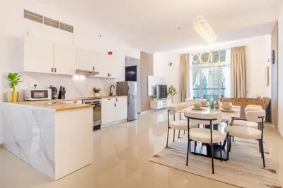 a kitchen and dining room with a table and chairs at Luxury 3BHK in Dubai Marina DEC 1307 in Dubai