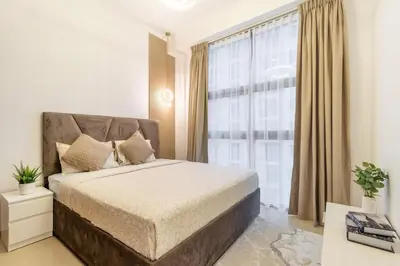 a bedroom with a bed and a large window at Luxury 3BHK in Dubai Marina DEC 1307 in Dubai