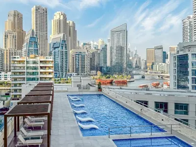 a pool on the roof of a building with a city at Luxury 2 BHK with Floating Bed in Dubai Marina DEC 1803 in Dubai