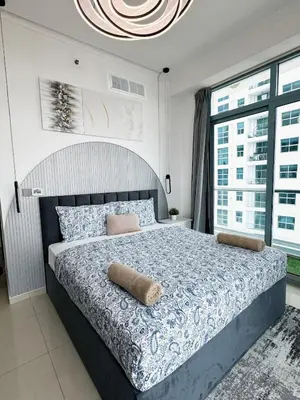 a bedroom with a large bed with a large window at Luxury 2 BHK with Floating Bed in Dubai Marina DEC 1803 in Dubai