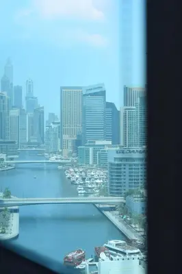 a view from a window of a city with a harbor at Luxury 2 BHK with Floating Bed in Dubai Marina DEC 1803 in Dubai