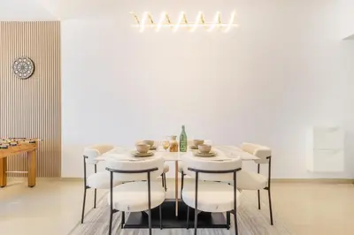 a dining room with a white table and chairs at Lux 3BHK in Dubai Marina w Marina View DEC 1407 in Dubai