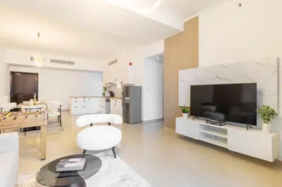 a living room with a large television and a table at Lux 3BHK in Dubai Marina w Marina View DEC 1407 in Dubai