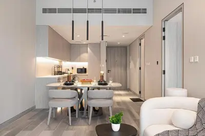 a kitchen and living room with a table and chairs at Luxury 1 BHK in Jumeirah Village Circle BydPie Concept 302 in Dubai
