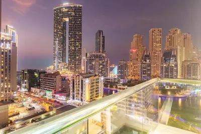 a city skyline at night with tall buildings at Luxury 3 BHK in Dubai Marina By dPie Dec 1007 in Dubai