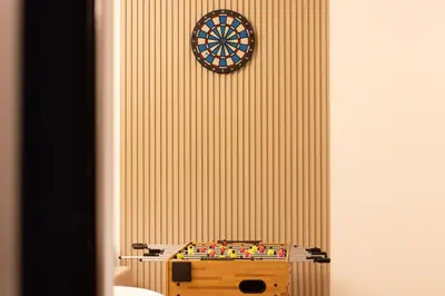 a dart board on a wall with a clock on it at Luxury 3 BHK in Dubai Marina By dPie Dec 1007 in Dubai