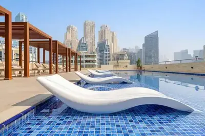 a swimming pool with two white objects on top of it at Luxury 3 BHK in Dubai Marina By dPie Dec 1007 in Dubai