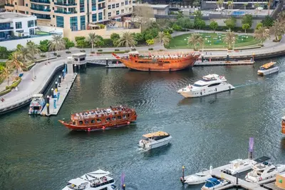 a group of boats in a river with other boats at Luxury 3 BHK in Dubai Marina By dPie Dec 1007 in Dubai