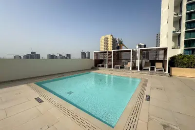 a swimming pool on the roof of a building at Charming 1Bedroom in Binghatti Gardenia in Dubai