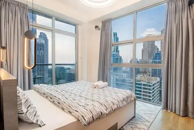 a bedroom with a bed and a large window at Lux 3BHK in Dubai Marina with Marina View DEC 1306 in Dubai