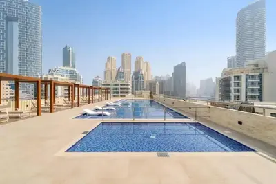 a swimming pool on the roof of a building at Lux 3BHK in Dubai Marina with Marina View DEC 1306 in Dubai