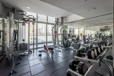 a gym with lots of cardio equipment in a building at Luxury 3BHK in Dubai Marina DEC 702 in Dubai