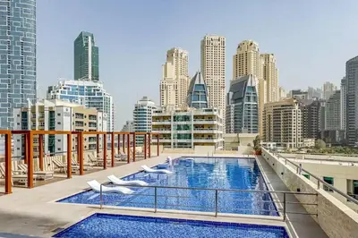 a balcony with a swimming pool on top of a building at Luxury 3BHK in Dubai Marina DEC 702 in Dubai