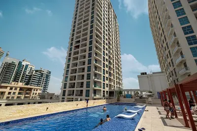 a swimming pool in a city with a tall building at Luxury 3BHK in Dubai Marine By dPie DEC 903 in Dubai