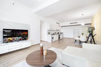a living room with a white couch and a table at Luxury 3BHK in Dubai Marine By dPie DEC 903 in Dubai