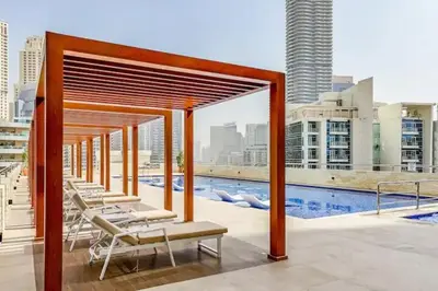 a group of lounge chairs on the roof of a building at Luxury 3BHK in Dubai Marine By dPie DEC 903 in Dubai