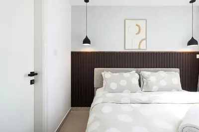 a bedroom with a bed with white sheets and pillows at Luxury 3BHK in Dubai Marine By dPie DEC 903 in Dubai