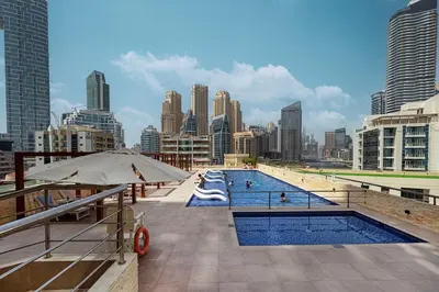 a swimming pool with a city in the background at Luxury 3BHK in Dubai Marine By dPie DEC 903 in Dubai