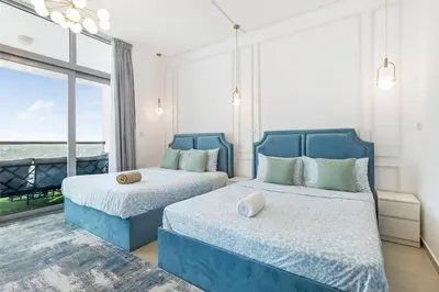 a bedroom with two blue beds and a large window at Luxury 4 BHK in Dubai Marina DEC 2102 in Dubai
