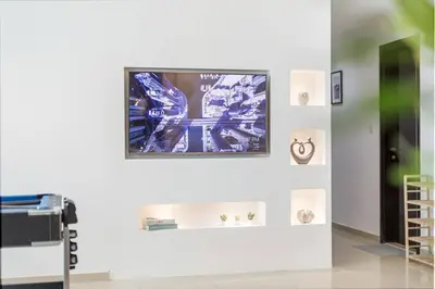 a room with a tv on a wall with pictures at Luxury 4 BHK in Dubai Marina DEC 2102 in Dubai